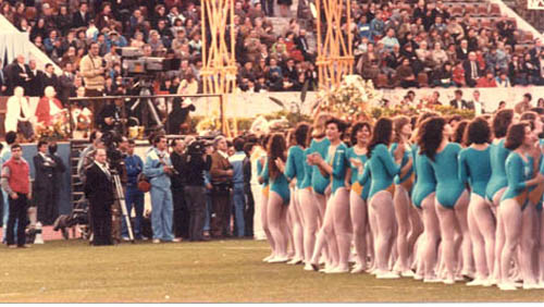 Girls in immodest leotards preparing to perform for John Paul II